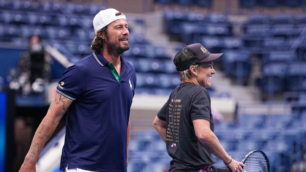Bethanie Mattek-Sands and Marat Safin talk tactics courtside during the exhibition
