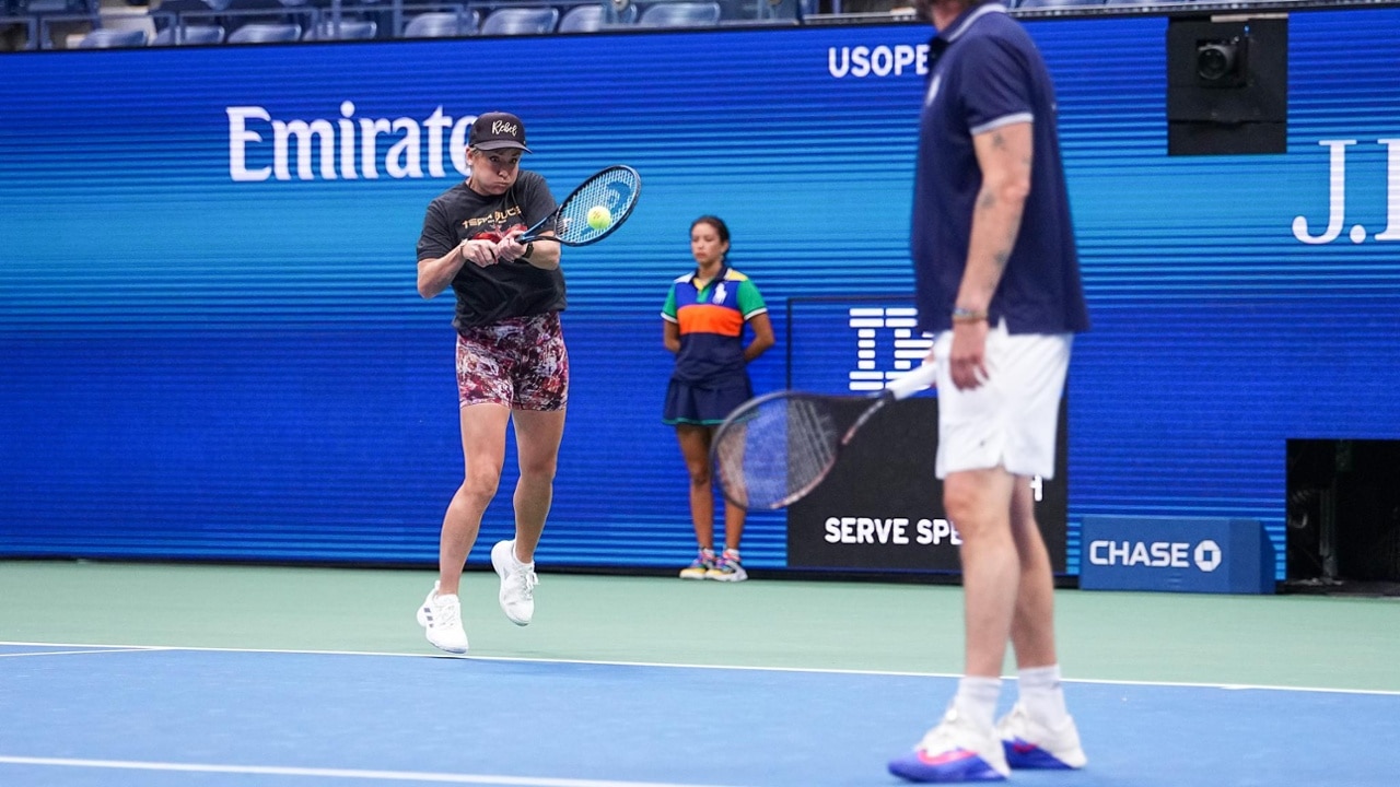 Bethanie Mattek-Sands fires a forehand, energizing the crowd with aggressive net play