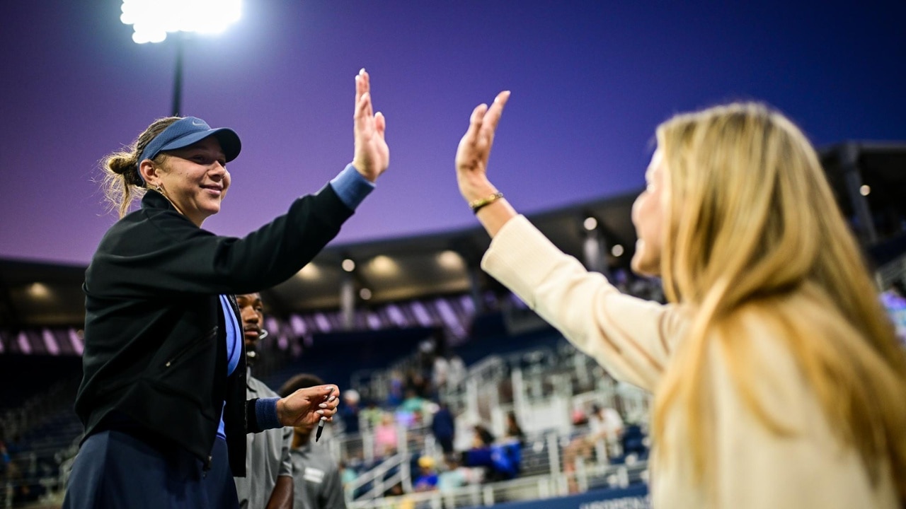 Amanda Anisimova high-fives a fan after a 2025 US Open match