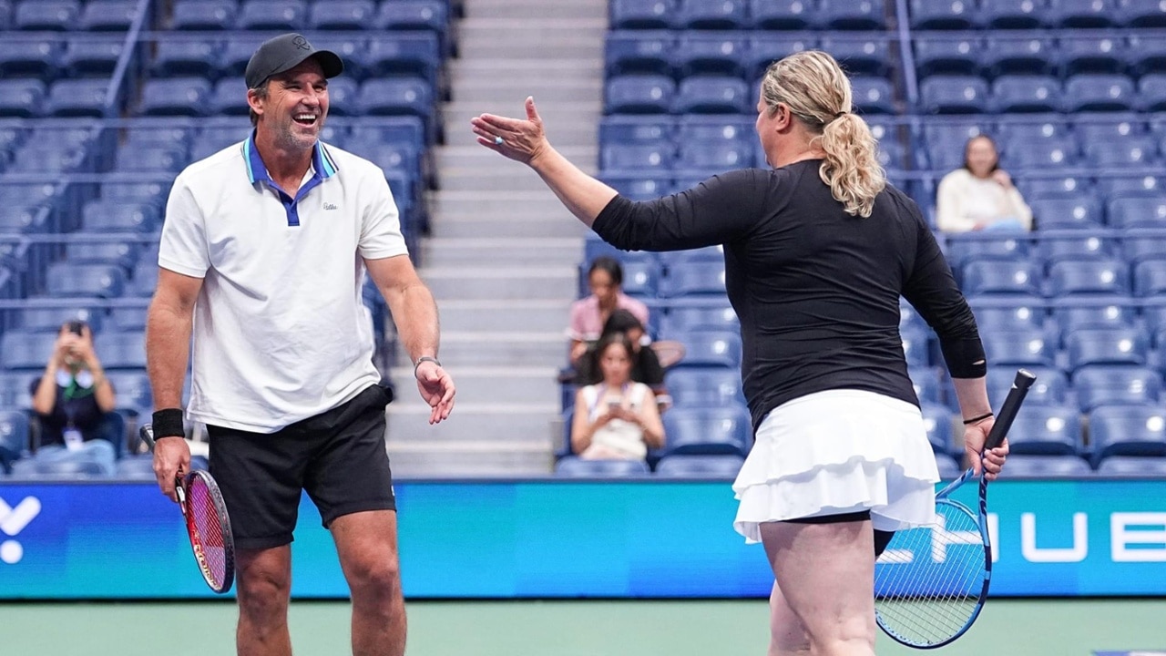 Clijsters and Rafter celebrate a point with a high-five during the Legends Match Event