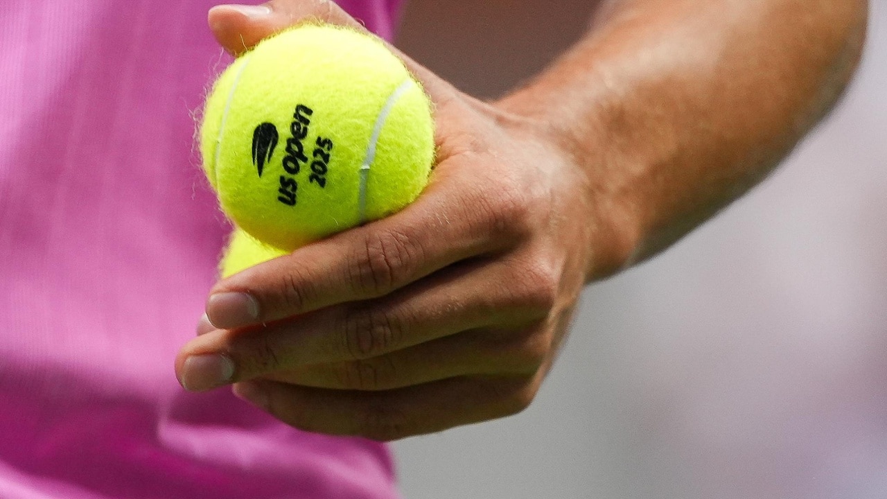Close-up of Carlos Alcaraz holding tennis balls during the men's final
