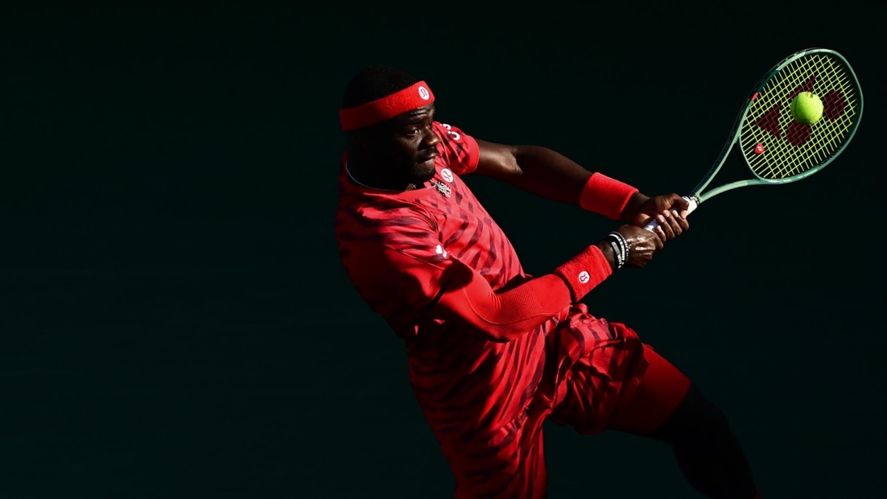 Frances Tiafoe slides into a forehand on the run