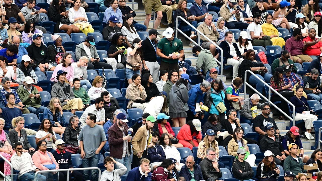 Crowd erupting during a high-intensity exchange on the big screen